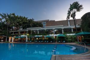 a large swimming pool in front of a building at Nairobi Serena Hotel in Nairobi