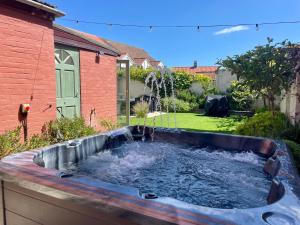 a pool of water in a yard with a fountain at Sheringham Luxury, Cinema, Hot Tub & Beach in Sheringham