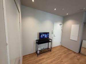 a living room with a television on a table in a wall at Spacious Retreat in Oslo