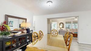 a dining room and living room with a table and chairs at Piney Glade - 18628 Sylvan Dr in Rehoboth Beach