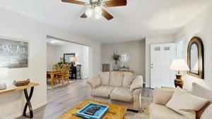 a living room with two chairs and a ceiling fan at Piney Glade - 18628 Sylvan Dr in Rehoboth Beach