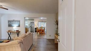 a living room with a couch and a table at Piney Glade - 18628 Sylvan Dr in Rehoboth Beach +16 photos