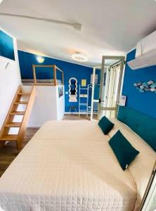 a bedroom with a large bed and a blue wall at Chianalea Guesthouse in Scilla