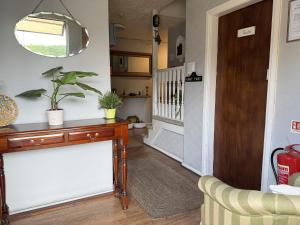 a living room with a console table and a hallway at Charde Guest House in Birmingham