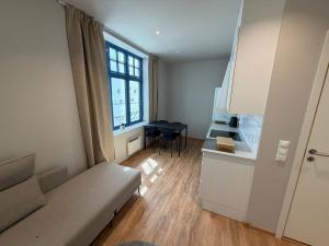 a small living room with a couch and a table at Spacious Retreat in Oslo +4 photos