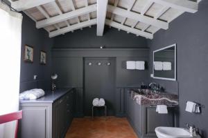 a bathroom with a sink and a toilet at Dimora DiVino in Palazzone +44 photos