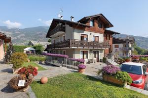 a house with a car parked in front of it at Au Petit Chevrot - Garden in Aosta
