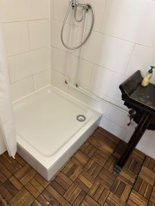 a white tub in a bathroom with a shower at Landhaus Butzbach in Butzbach