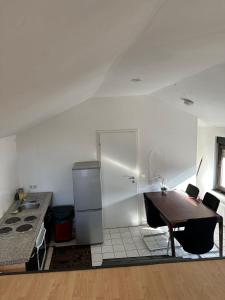 a kitchen with a wooden table and a refrigerator at Landhaus Butzbach in Butzbach +25 photos