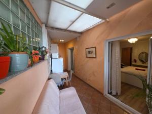a living room with a couch and a bedroom at Apartment relax jacuzzi terrace with sea view in Brela