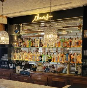 a bar with a lot of bottles of alcohol at Garfield Inn in Port Austin