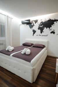 a bedroom with a large bed with a world map on the wall at Villa The One Mostar with Heated Pool & Jacuzzi in Mostar +41 photos