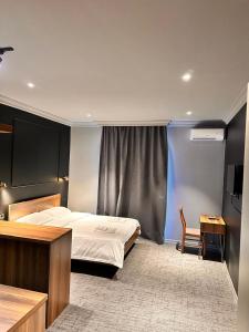 a bedroom with a bed and a table and a desk at Tropical Garden in Kobuleti +187 photos
