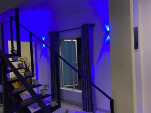 a purple room with a staircase and a window at mountain retreat villa in Kandy
