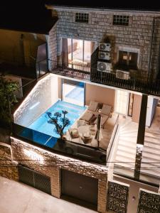 an overhead view of a house with a swimming pool at Villa The One Mostar with Heated Pool & Jacuzzi in Mostar