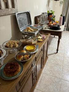 a buffet with many different types of food on it at Refúgio Aroma do Campo in Bagé +2 photos
