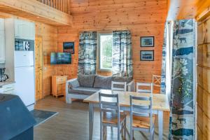 a kitchen and living room with a table and a couch at Jehkas Huoneisto B in Kilpisjärvi