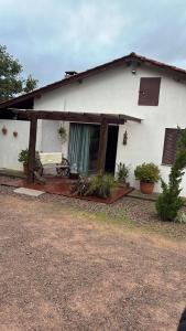 a white house with a patio in front of it at Refúgio Aroma do Campo in Bagé