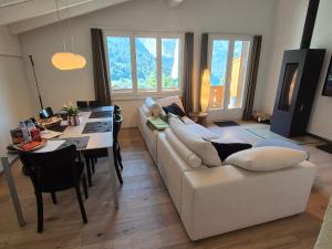 a living room with a white couch and a table at ABO - Boutique Apartment - Chalet Horst in Grindelwald