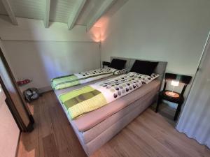 a bedroom with two beds and a chair at ABO - Boutique Apartment - Chalet Horst in Grindelwald