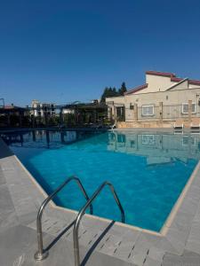 a large blue swimming pool with a metal hand rail at PMTR Residence in Bar