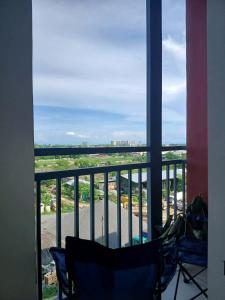a balcony with a view of a city at Sanctuary 5125 by Primeworld District in Agus
