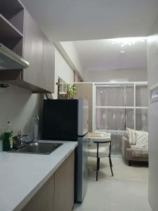 a kitchen with a sink and a counter top at Sanctuary 5125 by Primeworld District in Agus
