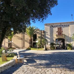 a white bench sitting in front of a building at B&B Vuiariello in Montefusco