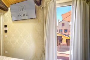 a bedroom with a window with a view of a courtyard at Hotel Falier in Venice +42 photos