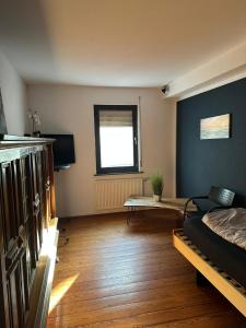 a room with a bed and a table in it at Landhaus Butzbach in Butzbach