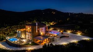 an aerial view of a mansion at night at Saronic Citadel Luxury Villa-Private Estate on Salamina Island in Salamina