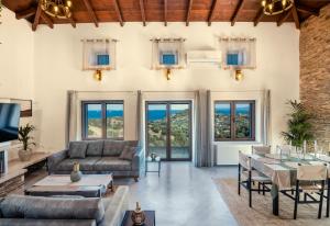 a living room with a couch and a table at Saronic Citadel Luxury Villa-Private Estate on Salamina Island in Salamina