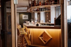 a bar in a restaurant with a bar stool at Kinderhotel Laderhof in Ladis
