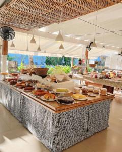 a buffet line with food on top of it at Ubatuba Palace Hotel in Ubatuba +39 photos