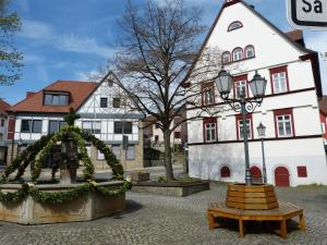 a bench in front of a building with a house at Ferienwohnung Nörpel in Igersheim