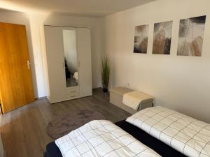 a bedroom with two beds and a mirror at Ferienwohnung Auszeit in Vöhl