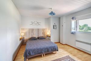 a bedroom with a bed in a white room at Gite xl proche Grottes Lascaux in Fossemagne +24 photos