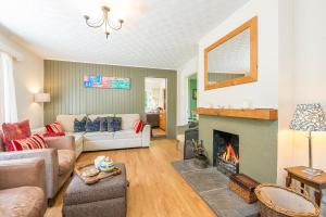 a living room with a couch and a fireplace at Glandraeth in Newport