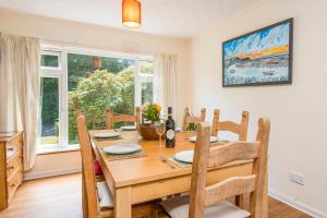 a dining room with a wooden table and chairs at Glandraeth in Newport