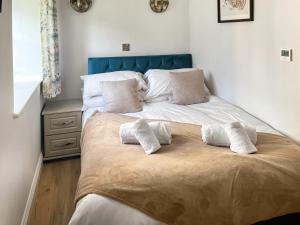 a bed with two pillows on it in a bedroom at The Barn - Uk50912 in Wansford