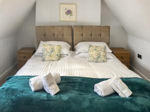 a bedroom with a bed with two towels on it at The Barn - Uk50912 in Wansford +21 photos