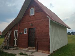 a red barn with a gambrel roof at Under Milky Way in Podgora +13 photos