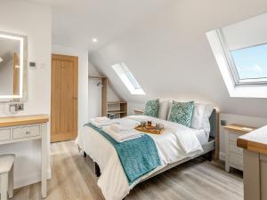 a bedroom with a bed and a sink and a window at Fallow's Holt in Buildwas