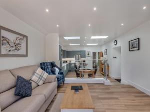 a living room with a couch and a table at The Old Byre in Edmondbyers +15 photos