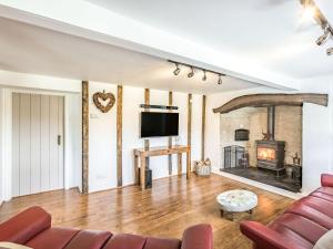 a living room with a couch and a fireplace at Heath Hills in Okehampton