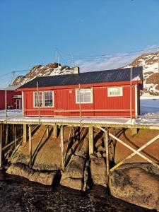 a red building on top of a bridge at Statles Rorbu- og Konferansesenter AS in Leknes +25 photos