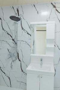 a bathroom with a white sink and a mirror at Astalanya City in Astara +12 photos
