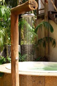 a water fountain in the middle of a garden at Casa Gili Moitas in Praia de Moitas