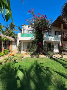 a house with a tree in front of it at Casa Gili Moitas in Praia de Moitas