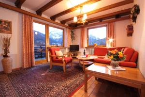 a living room with a couch and a table at Sporthotel Walliser in Hirschegg